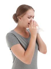 Young woman suffering from allergy on white background