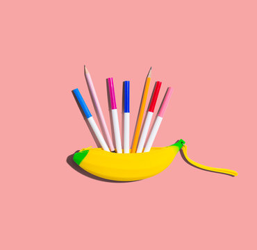 Banana shaped pen case with colorful pens and pencils