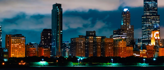 Downtown Chicago cityscape skyline at night with Lake Michigan in the foreground