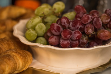 grapes in bowl on wooden table
