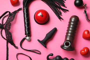 Set of different sex toys on pink background, flat lay