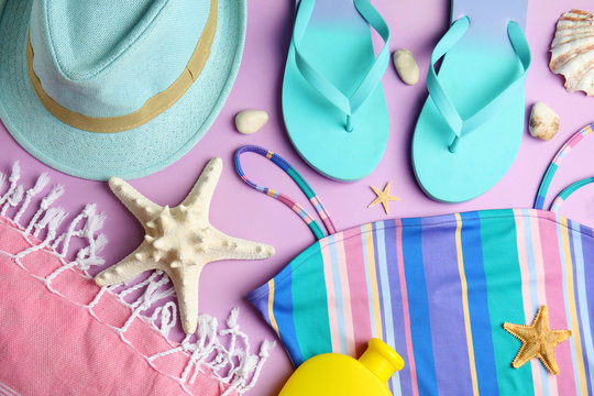 Flat lay composition with beach objects on lilac background
