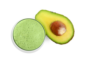 Glass of tasty smoothie and avocado on white background, top view