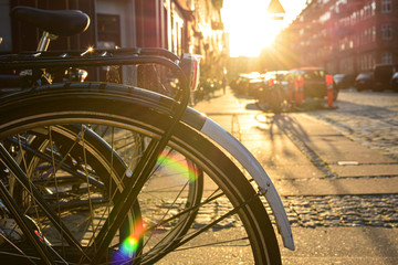 Bicycles on a street of Copenhagen, Denmark. Colorful old town architecture the sunset. Copenhagen style, European street, Denmark bicycle