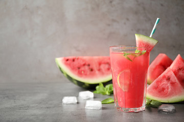 Glass of tasty refreshing drink with watermelon on grey table. Space for text - obrazy, fototapety, plakaty