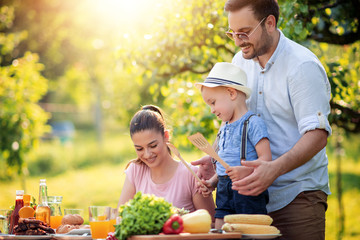 Happy family having a lunch in summer