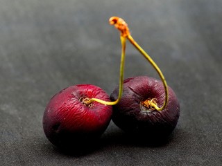 Ripe cherries over black background