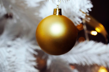 Christmas tree toy on the background of a white Christmas tree