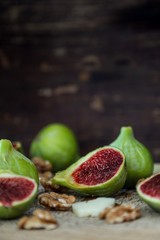 fresh figs, nuts and cheese on wooden table