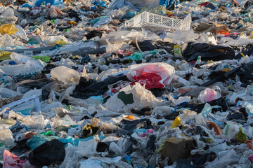 garbage dump with lot of plastic bag and bottles and other waste