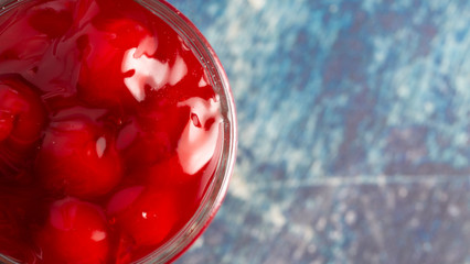 Glass Canning Jar Filled with Cherry Pie Filling on a Wooden Table