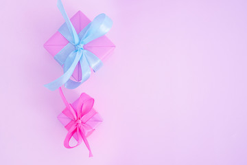 Two pink gift boxes with satin ribbones on pink background, congratulations on Women's Day, mum's day, Valentine's day, happy birthday, Christmas