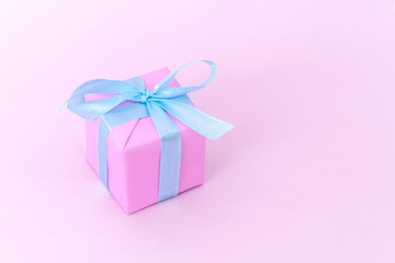 Gift pink box with blue satin ribbon on pink background, congratulations on Women's Day, mum's day, Valentine's day, happy birthday, Christmas