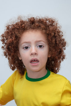Child with green and yellow  shirt celebrating brazil game and independence.