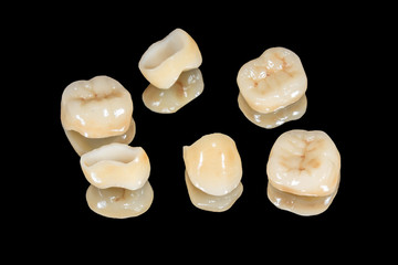 ceramic crowns of human teeth closeup macro isolate on a black background. The concept of aesthetic dentistry