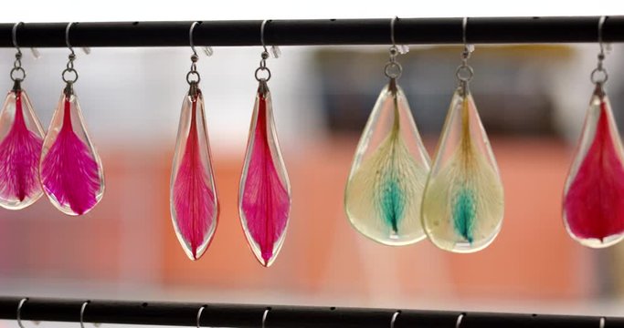 Trendy earrings hanging on dislay - close up - colorful