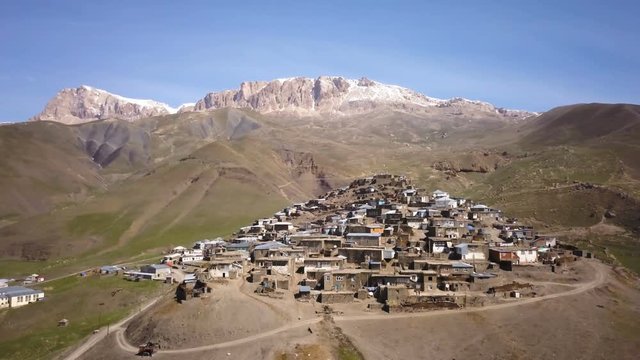 Aerial View Of Old Village With Snow Covered Mountain In The Background