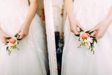 Obraz na płótnie Canvas wedding bouquet. bride holds boutonniere