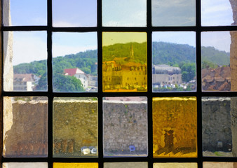 Rooftops over Old Annecy seen from colored windows at the Annecy castle in Annecy, Haute Savoie, France.