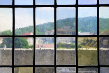 Rooftops over Old Annecy seen from colored windows at the Annecy castle in Annecy, Haute Savoie, France.