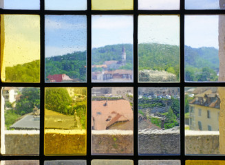 Rooftops over Old Annecy seen from colored windows at the Annecy castle in Annecy, Haute Savoie, France.