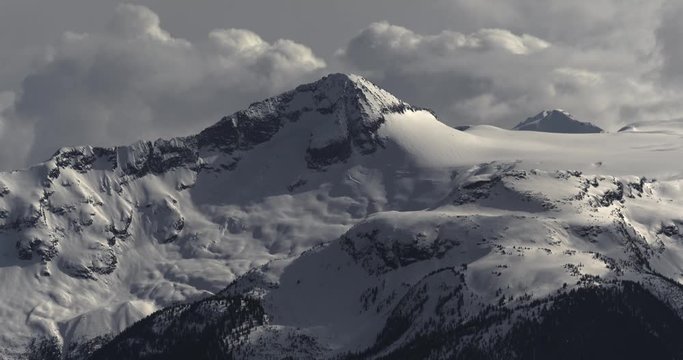 4K Time Lapse of Dramatic Snow Covered Alpine Peak Surrounded by Storm Clouds