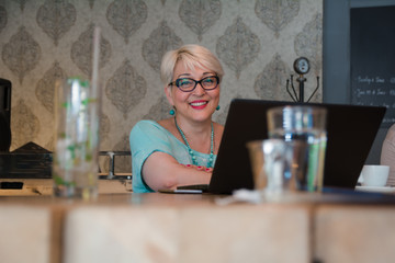 Beautiful mature woman working on laptop