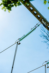 Low angle view of high voltage French power lines against blue sky background at the hydroelectric power plant at Centrale Hydroelectrique de Gambsheim