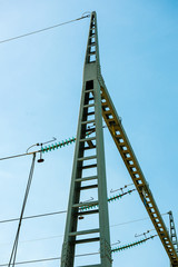 Low angle view of high voltage French power lines against blue sky background at the hydroelectric power plant at Centrale Hydroelectrique de Gambsheim