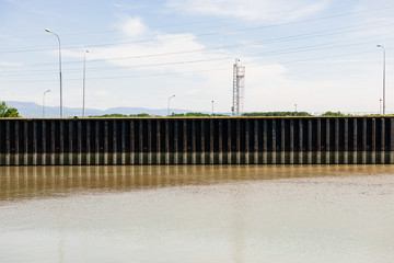 Protection dam on the Rhine river with calm waters