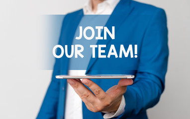 Handwriting text Join Our Team. Conceptual photo invite someone to work together for particular purpose target Man in the blue suite and white shirt holds mobile phone in the hand