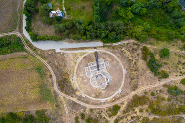 Aerial view of ancient ruin church with odd shapes on the land.  Circles in the land
