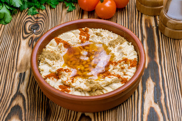 Traditional homemade hummus on wooden table. Turkish cuisine.