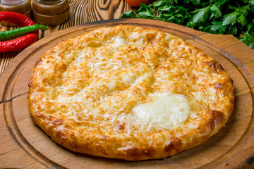 khachapuri with cheese on wooden table