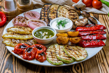 grilled vegetables on a plate on wooden table. Turkish cuisine.