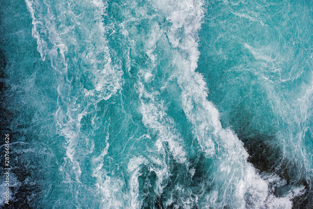 Wall mural bruarfoss waterfall in iceland as an abstract of the blue water and whitewater from above