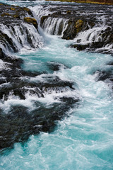 Bruarfoss waterfall in Iceland showing it's true blue colors on a cold spring day