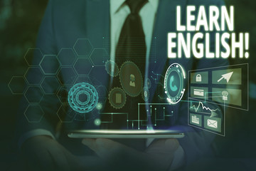 Writing note showing Learn English. Business concept for gain acquire knowledge in new language by study Male wear formal suit presenting presentation smart device