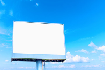 Fototapeta premium Blank billboard mockup with white screen against clouds and blue sky background. Copy space banner for advertisement. Business Concept.