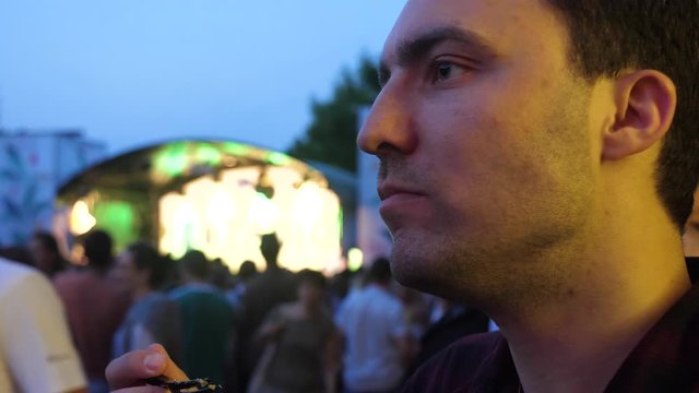 Man eating fastfood at festival.