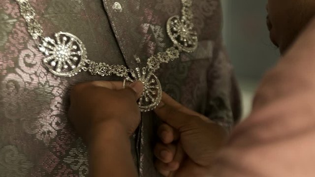 Asian Man preparing for the marriage in Baju pengantin songket.