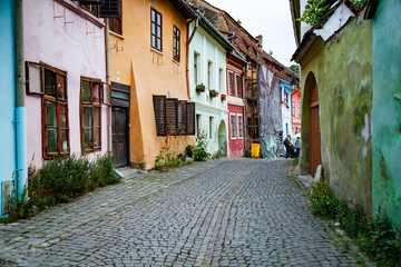 Fototapeta na wymiar colorful houses in the medieval town of Sighisoara, Transylvania, Romania - touristic destination