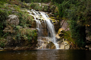 Fototapeta na wymiar A beautiful waterfall forming lake of murky waters, Ibotipoca State Park