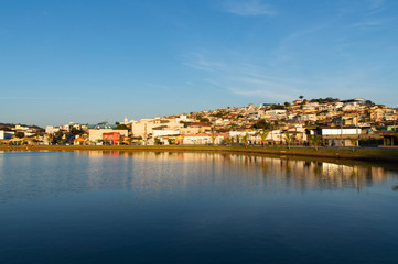 Fototapeta na wymiar small inland town reflected in large lake, Capitólio, Minas Gerais