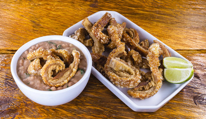 Traditional Brazilian recipe for pork crackling called pork crackling. Traditional Brazilian food, fried and crispy pork accompanied by bean tutu.