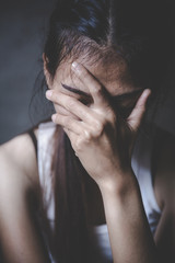 Scared young woman sitting in the corner of her bedroom, despair rape victim waiting for help,The...