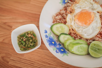 Stir fried rice, minced pork and basil topped with fried egg. Thai famous food.Macro shot of delicious Asian vegetable rice cuisine