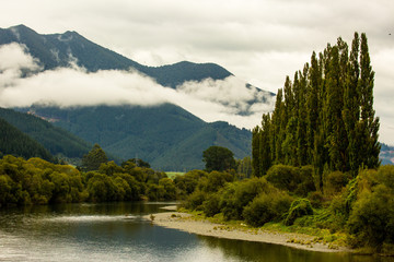 Peaceful calm river winding its way through rural countryside in Nelson New Zealand