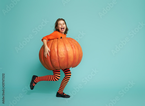 little girl in pumpkin costume