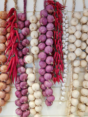 Mixed herbs Chillies, Onions and garlics hang on white wooden background. Food concept.